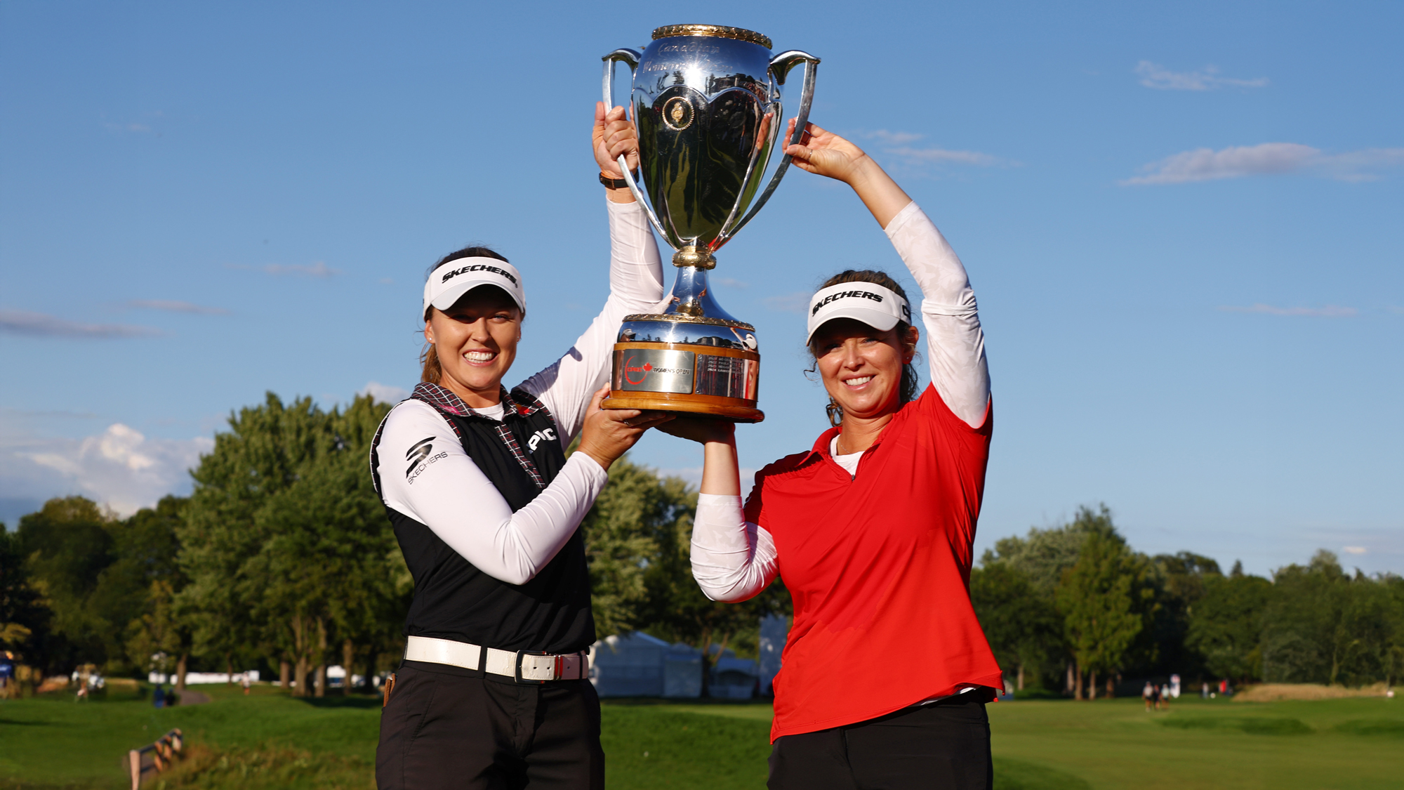 Brooke M. Henderson of Canada and her sister and caddie Brittany Henderson pose with the trophy after Brooke won the CPKC Women's Open 2025 at Mississaugua Golf and Country Club on August 24, 2025 in Mississauga, Ontario