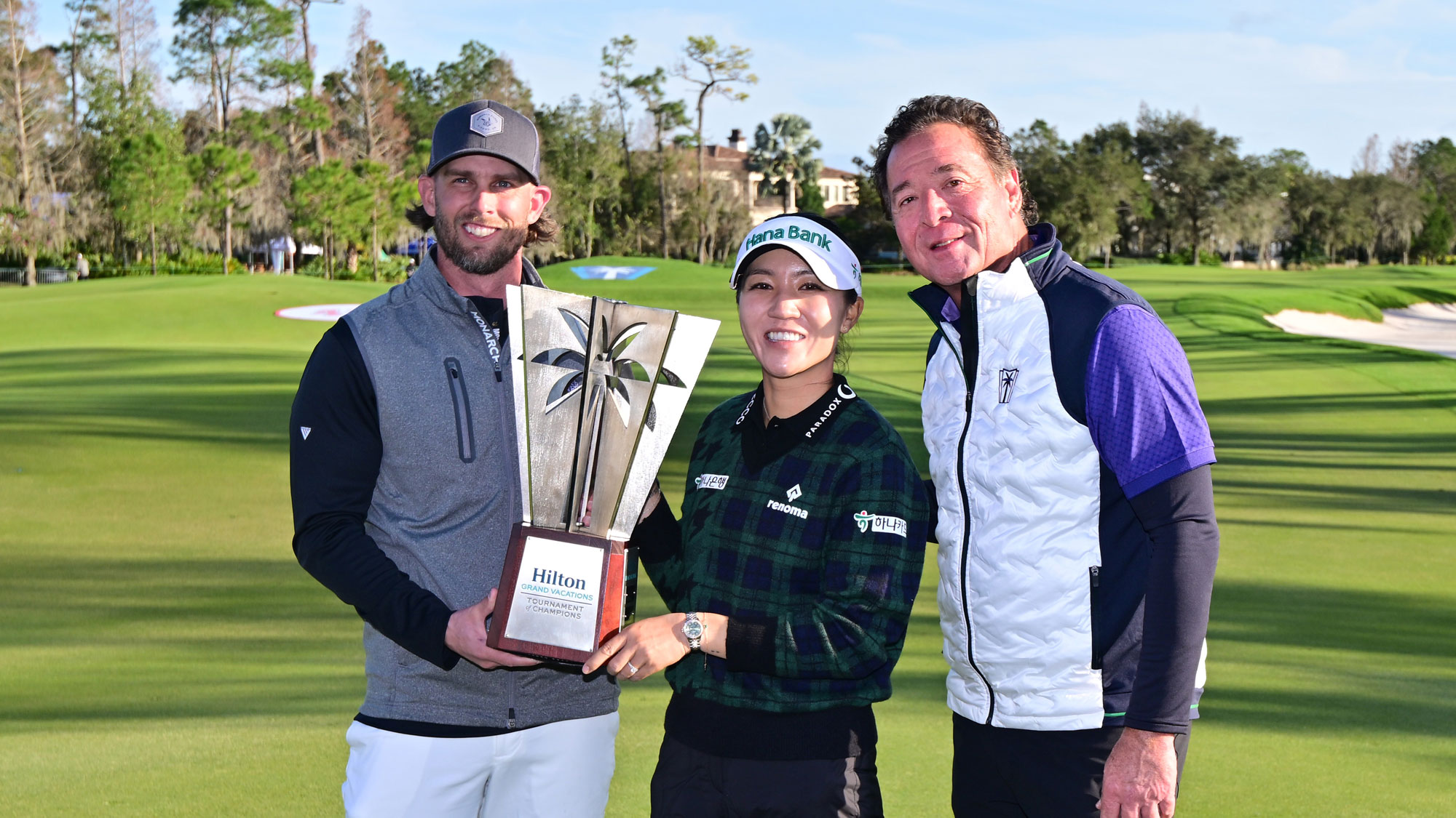 (L-R) Professional baseball player Jeff McNeil, Lydia Ko of New Zealand and President, Chief Executive Officer and a Director of Hilton Grand Vacations Mark Wang pose with the trophy after the Hilton Grand Vacations Tournament of Champions at Lake Nona Golf & Country Club on January 21, 2024 in Orlando, Florida