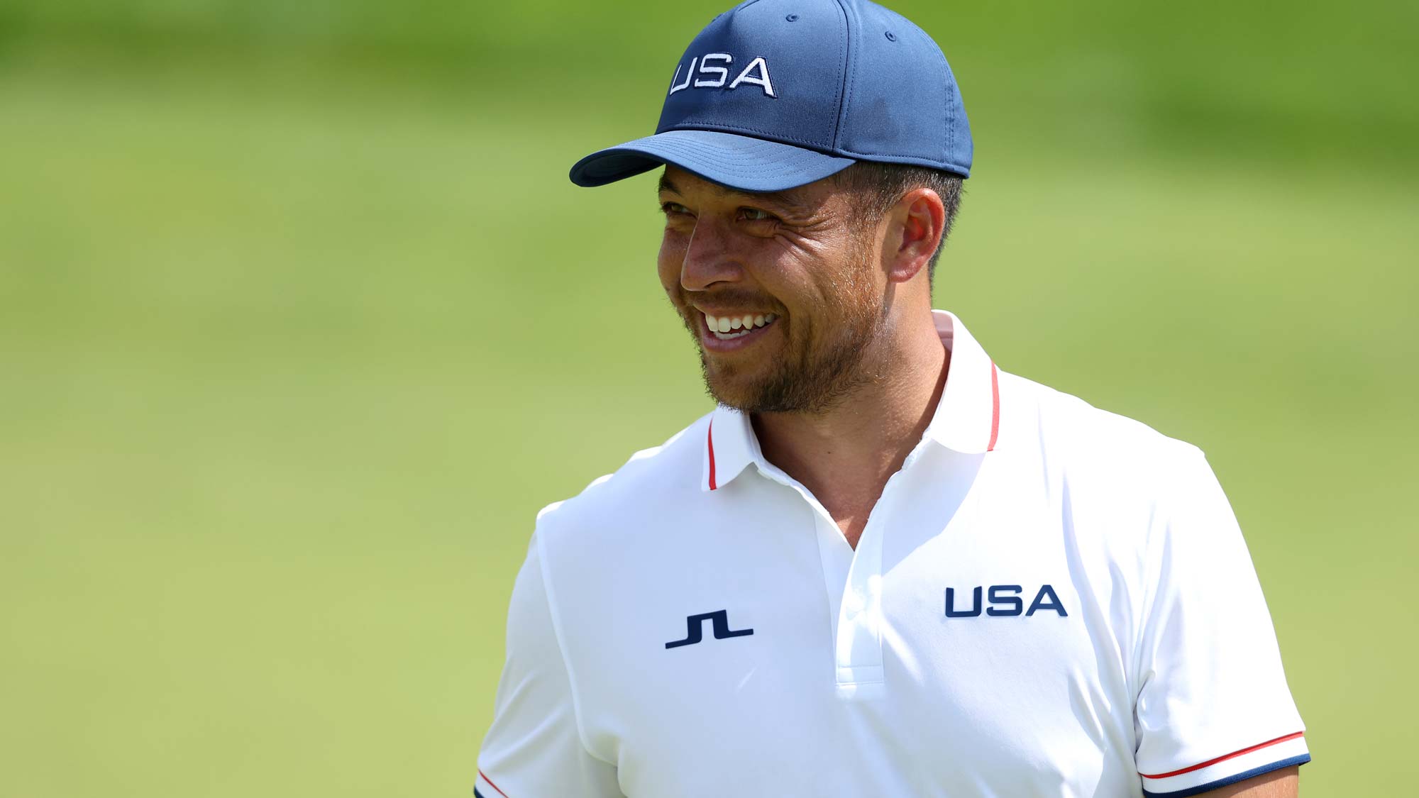 Xander Schauffele of Team United States smiles on the 13th green during a practice round on day five of the Olympic Games Paris 2024 at Le Golf National