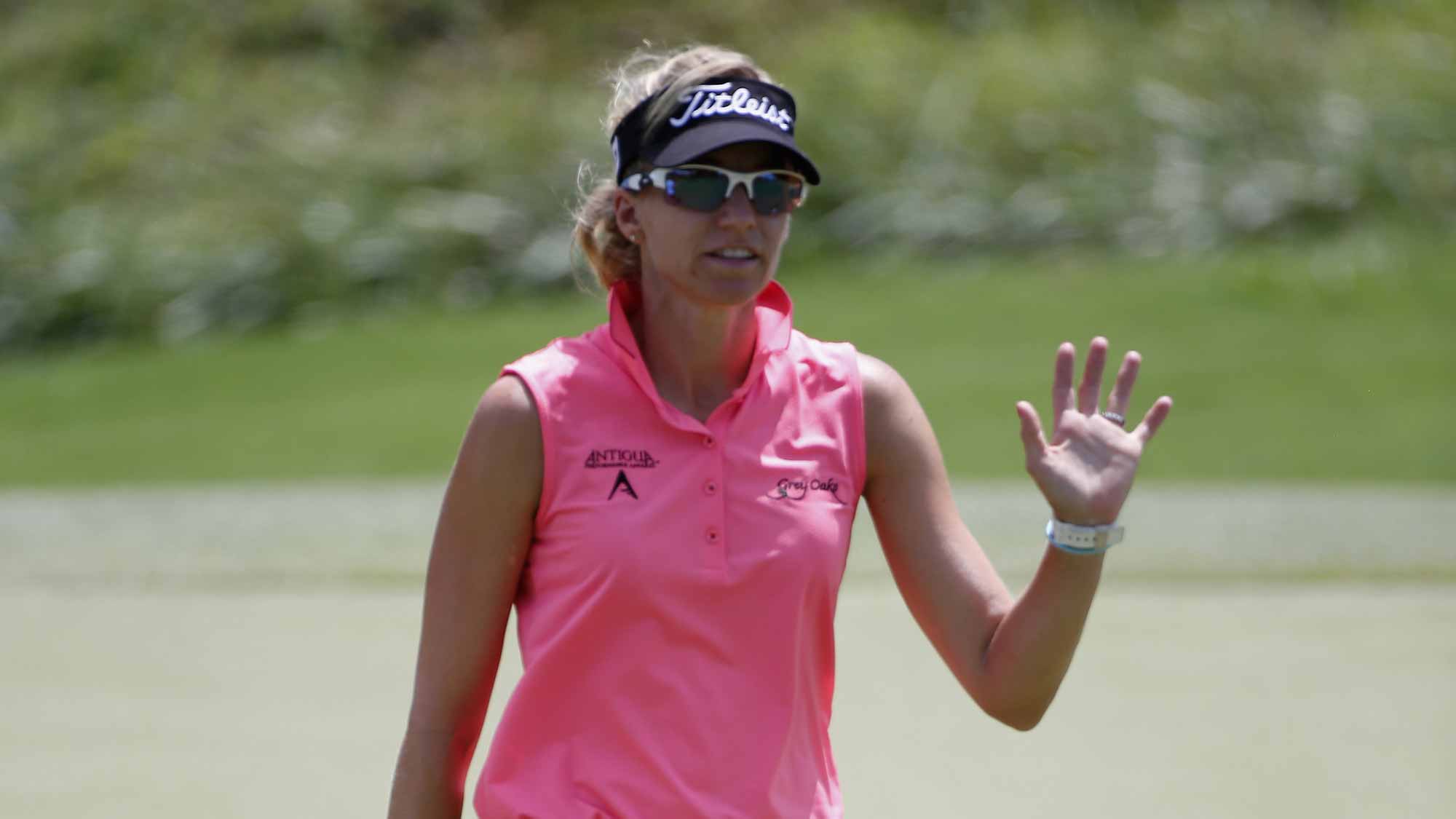 Kris Tamulis acknowledges the crowd after a putt on the 4th hole during the final round of the Yokohama Tire LPGA Classic at the Robert Trent Jones Golf Trail at Capitol Hill 