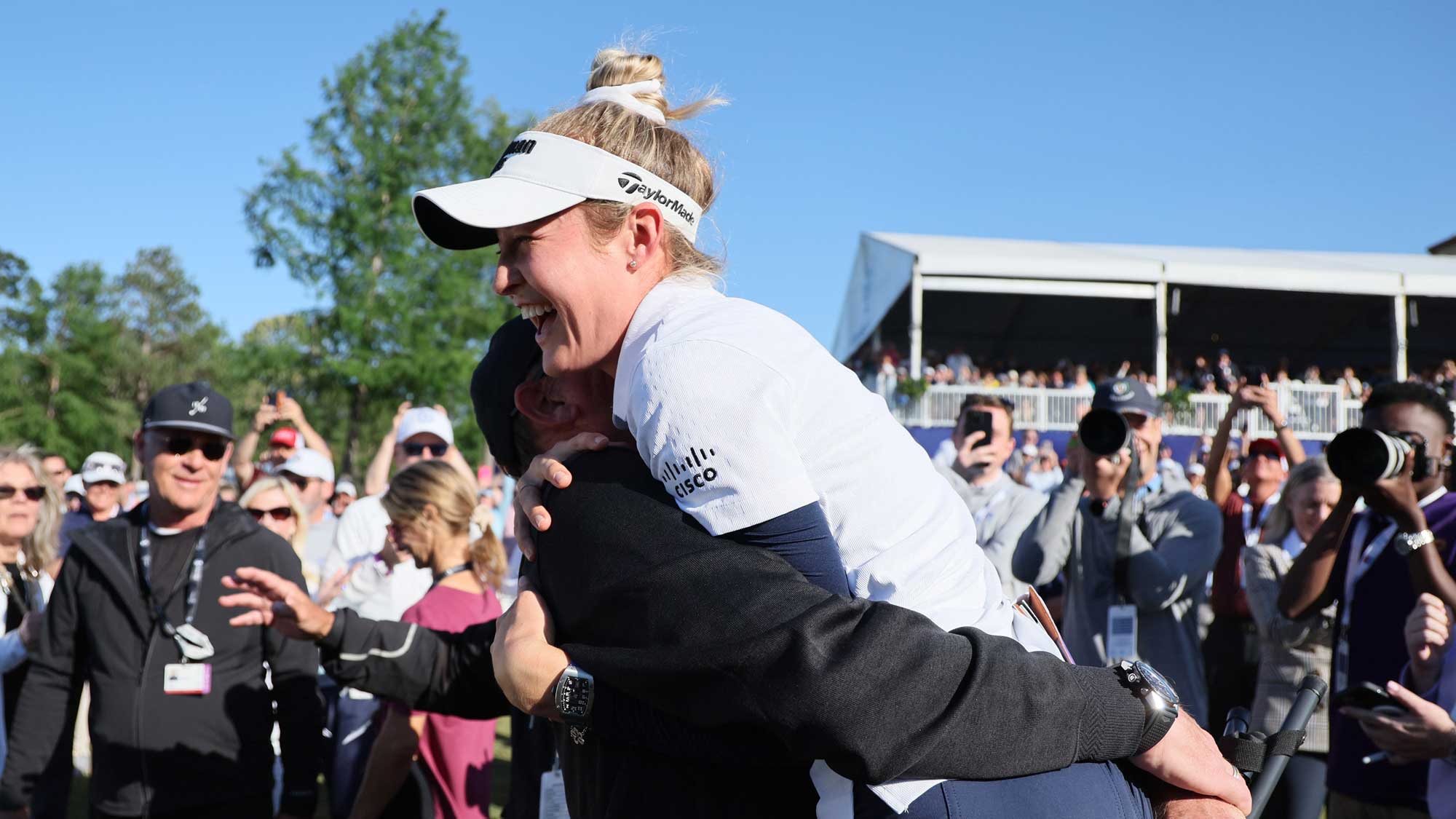 Nelly Korda being picked up in a hug by her dad Petr Korda