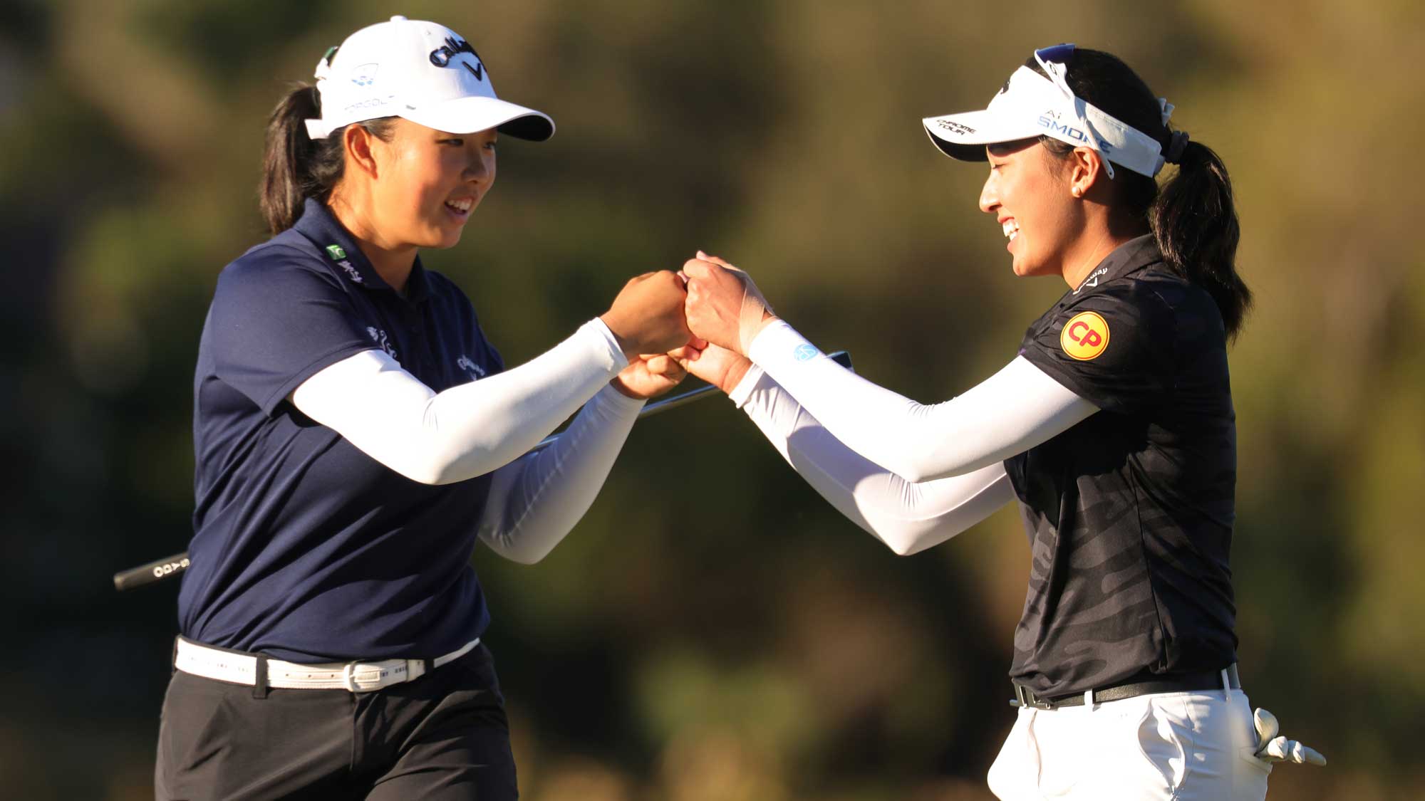 Ruoning Yin of China and Jeeno Thitikul of Thailand react on the 17th green during the third round of the CME Group Tour Championship 2024 at Tiburon Golf Club on November 23, 2024 in Naples, Florida.