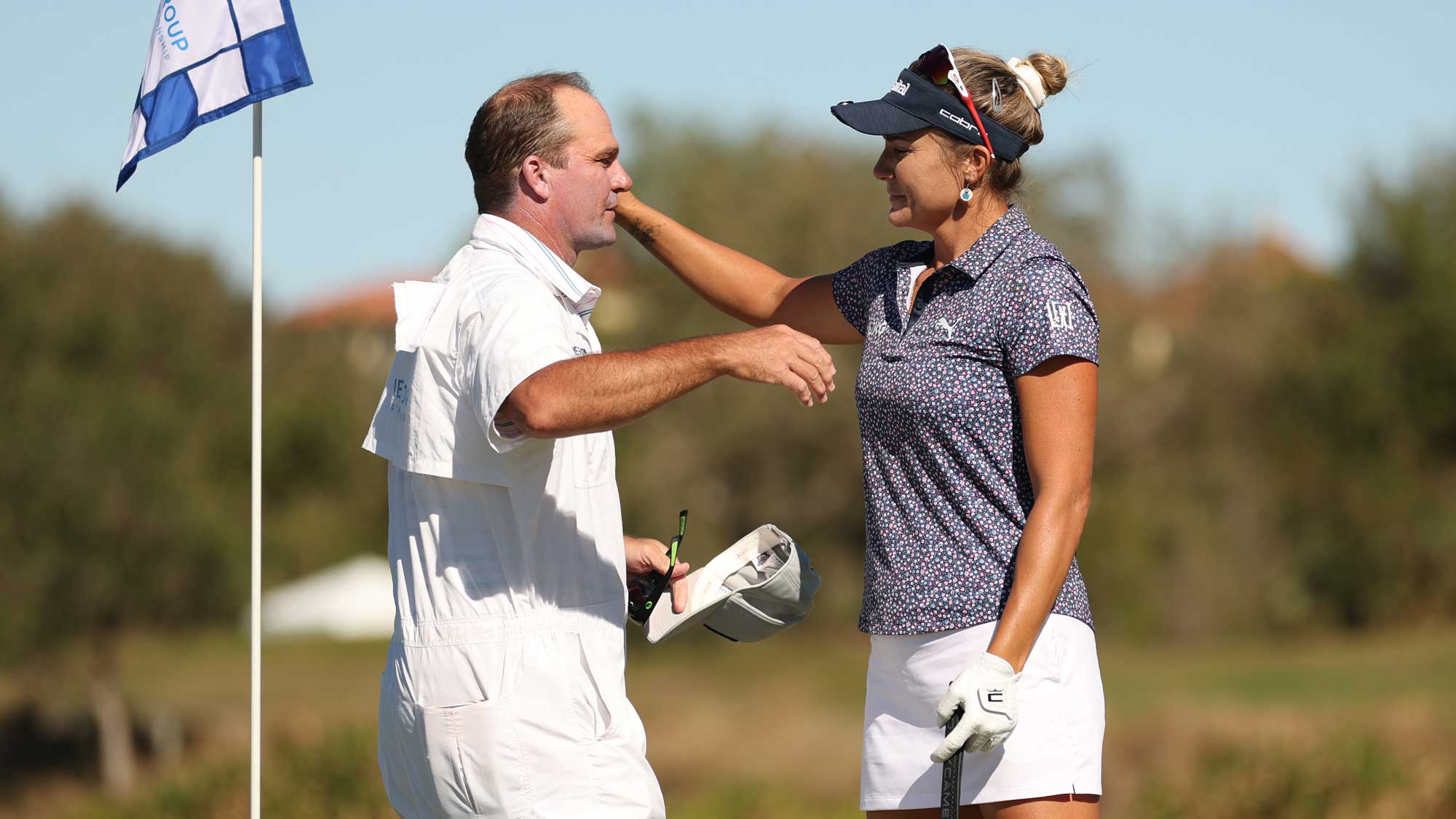 Lexi Thompson of the United States reacts with caddie and brother Nicholas Thompson after finishing on the ninth green during the final round of the CME Group Tour Championship 2024 at Tiburon Golf Club on November 24, 2024 in Naples, Florida. Thompson announced her decision to retire from professional golf at the conclusion of the 2024 season earlier in the year.