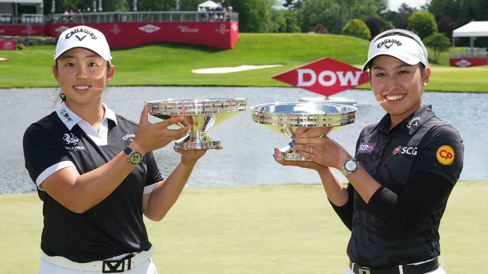Ruoning Yin of China (L) and Atthaya Thitikul of Thailand pose with the trophy after winning the Dow Championship at Midland Country Club on June 30, 2024 in Midland, Michigan.