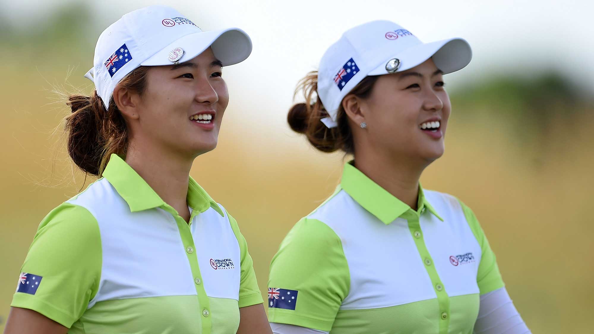 (L) Su Oh and (R) Minjee Lee of Australia walk off the 4th tee during the four-ball session of the 2016 UL International Crown