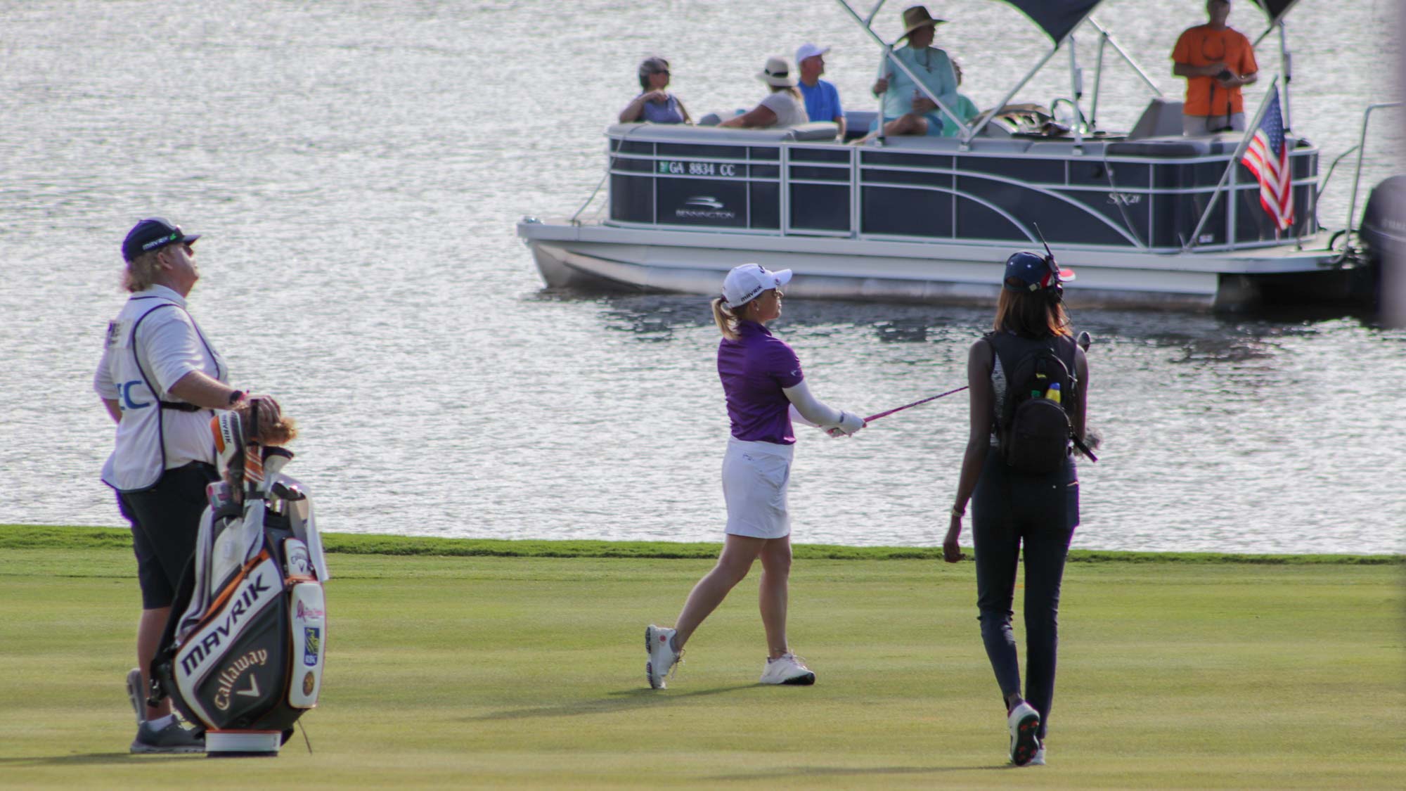 Morgan Pressel hits her shot in front of a group of fans on a boat during round 3 of the LPGA Drive On Championship - Reynolds Lake Oconee