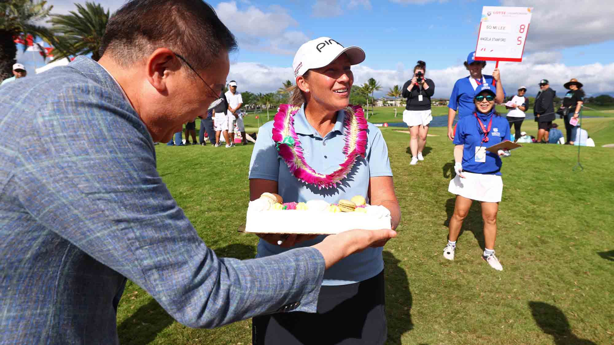 Angela Stanford of the United States is presented with a cake for her retirement after finishing on the 18th green during the final round of the LOTTE Championship presented by Hoakalei 2024 at Hoakalei Country Club on November 09, 2024 in Ewa Beach, Hawaii. 