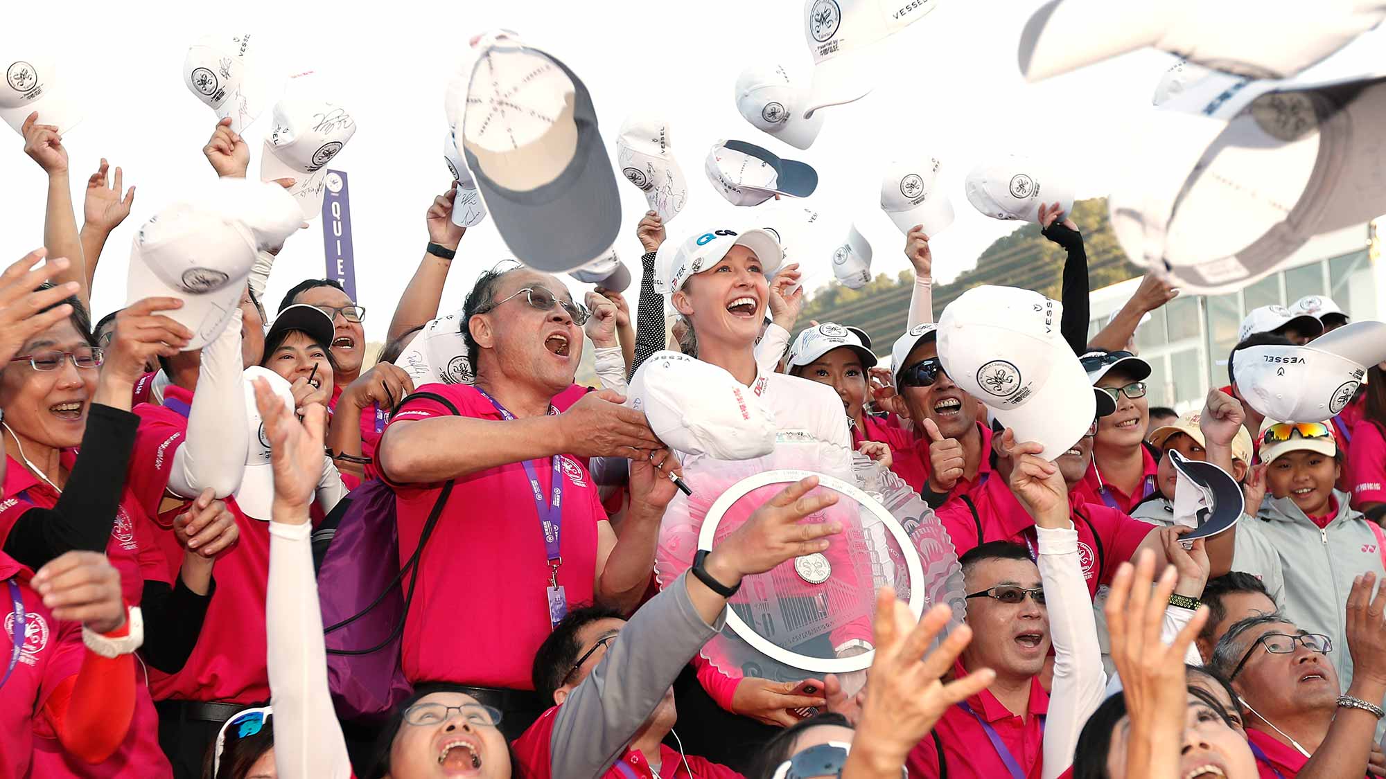 Nelly Korda poses with her trophy and with volunteers on the 18th green after winning the Swinging Skirts LPGA Taiwan Championship at Ta Shee Golf & Country Club on October 28, 2018 in Taoyuan, Chinese Taipei