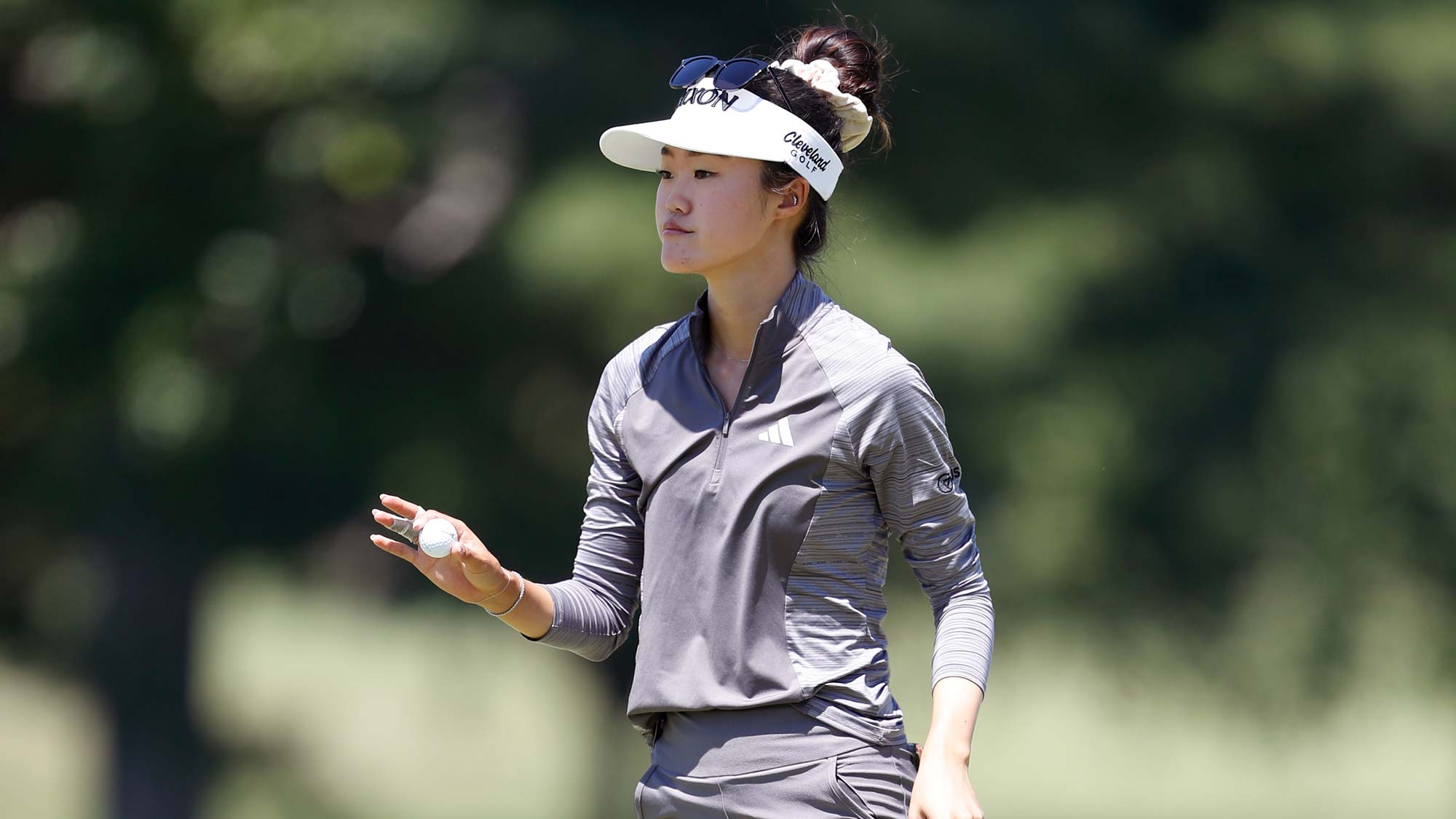 Grace Kim of Australia acknowledges the crowd after a putt on the eighth green during the second round of the Meijer LPGA Classic for Simply Give at Blythefield Country Club