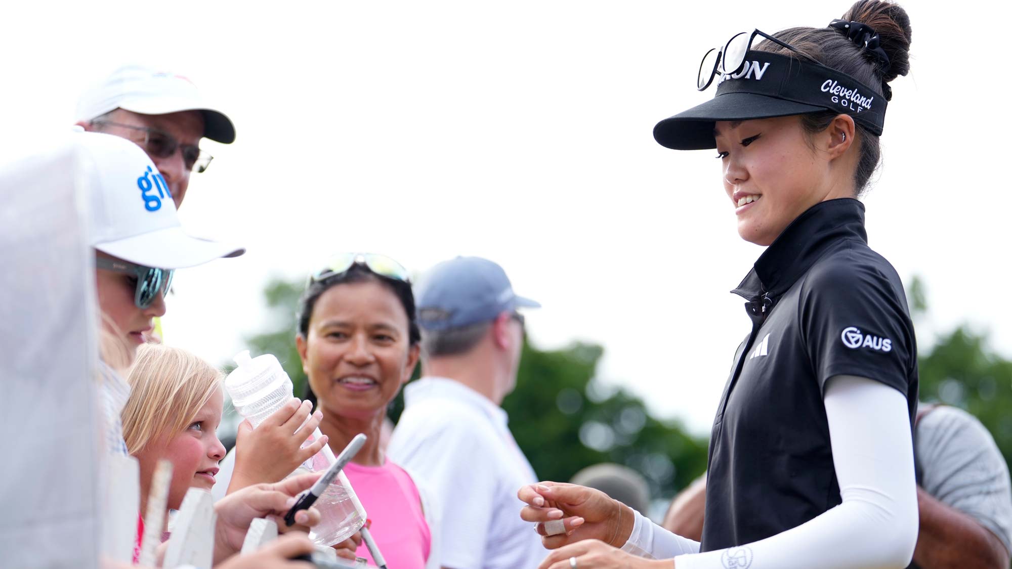 Grace Kim of Australia signs autographs after completing the third round of the Meijer LPGA Classic for Simply Give at Blythefield Country Club