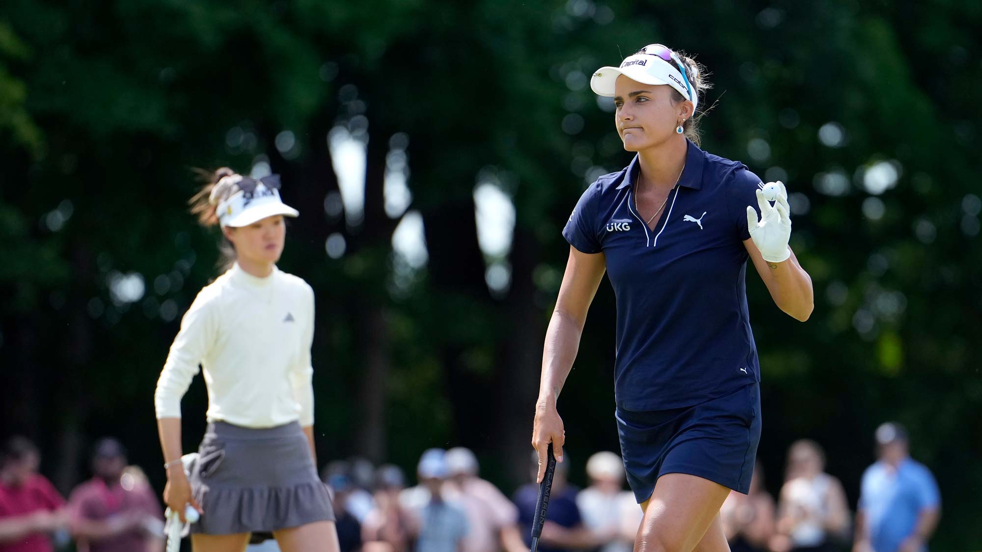 Lexi Thompson of the United States acknowledges the crowd after a putt on the third green during the final round of the Meijer LPGA Classic for Simply Give at Blythefield Country Club