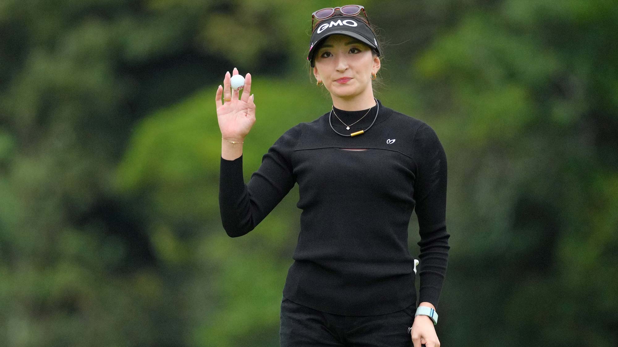 Hana Wakimoto of Japan acknowledges the gallery after holing out with the birdie on the 18th green during the second round of the TOTO Japan Classic 2024